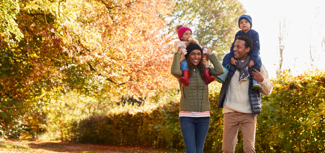 a couple walking with their two children