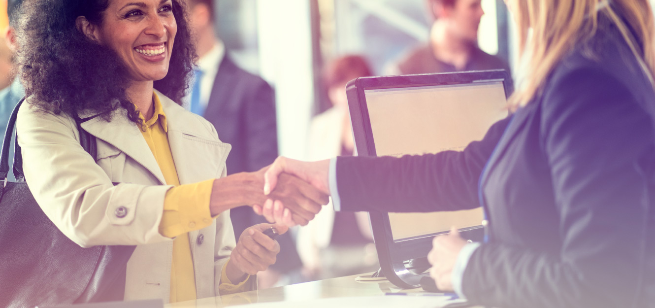 two women shaking hands