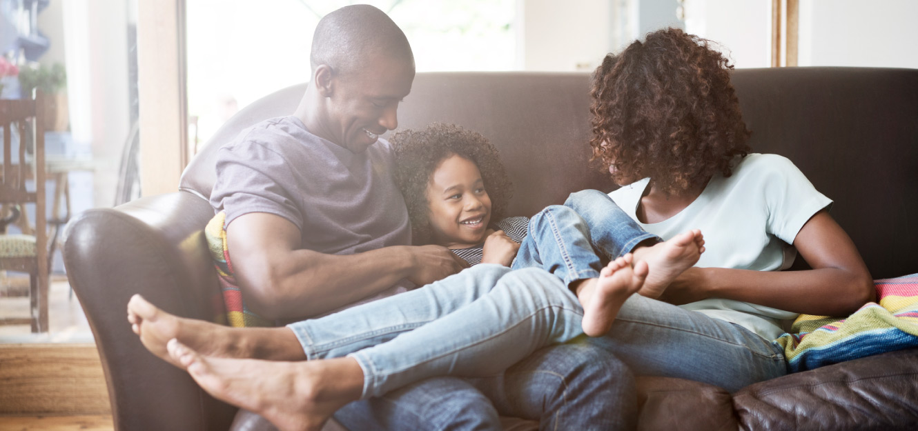 a family sitting on the couch together