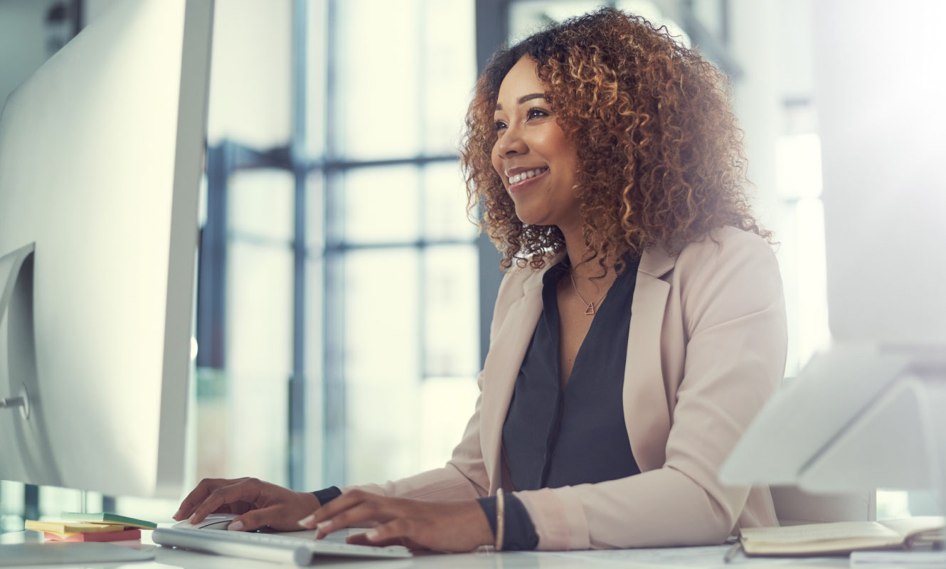 woman using her computer at desk